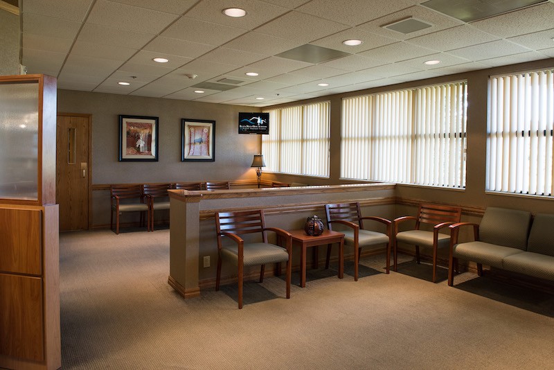 Waiting room with large windows at {PRACTICE_NAME}